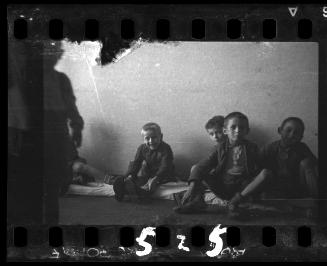 Children sitting on floor mats, probably in the ghetto orphanage
