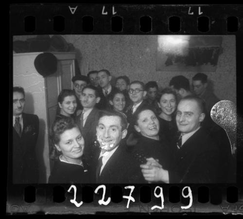 Residents dancing and smiling at a wedding reception in the ghetto