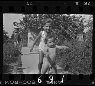 A boy catching up with a baby