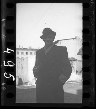 Well dressed Jewish man smoking a cigratte on the street [probably a member of the Judenrat, the Jewish Council]