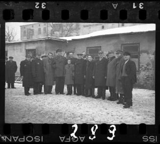 Workers of the Transport Department standing outside of a building in the winter