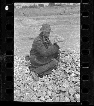 Man sitting on a pile of rocks