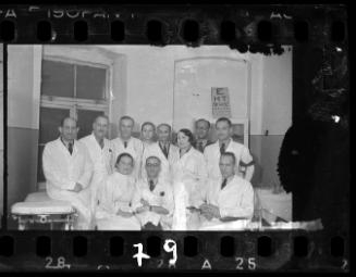 Group portrait of doctors in white coats with Dr. Kagan, administrative director of the hospital