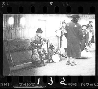 An elderly ghetto resident sitting with belongings prior to deportation