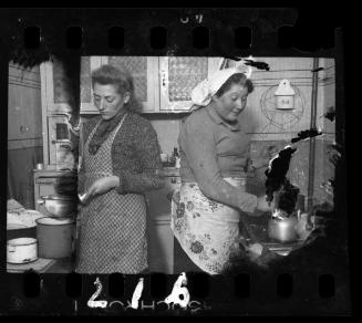 Stefania Schoenberg (left) and an unidentified woman in the kitchen