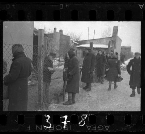 Residents talking through prison fence