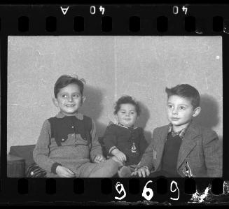 Portrait of a baby with two boys