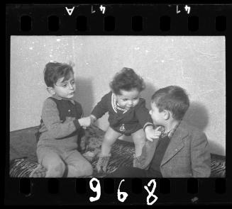 Portrait of a baby with two boys