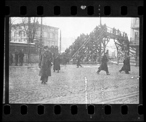 Lodz Ghetto residents crossing the Zigerska Street bridge, spanning over the "Aryan" street