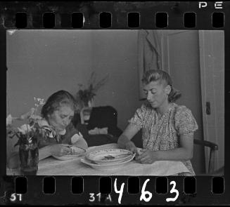 Stefania Schoenberg (right) and an elderly woman eating soup