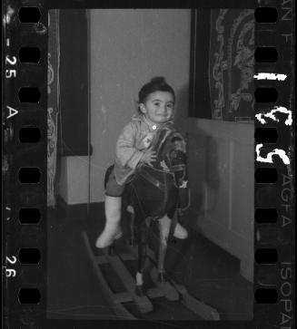 Portrait of a young child on a rocking horse