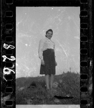 Woman in white shirt and dark skirt