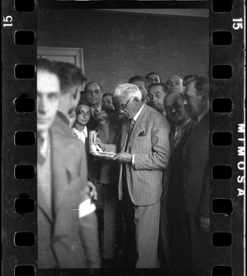 Mordechai Chaim Rumkowksi, Elder of the Jews, recieving a gift, among Jewish police officers and administrators