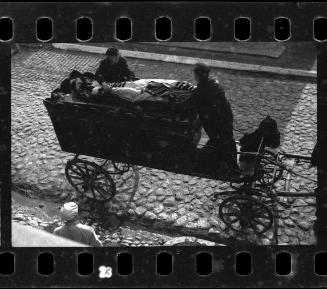Residents placing corpse onto a hearse