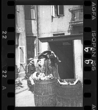 Barrels containing foodstuff in a courtyard in the ghetto