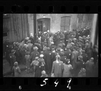 Residents gathered outside the doorway of building #44 in the ghetto