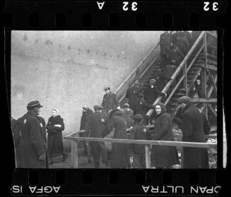 Residents walking up the stairs to the pedestrian bridge crossing Zigerska Street, the "Aryan" street that divided the ghetto into two areas