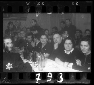 Residents sit around the table at a wedding reception in the ghetto