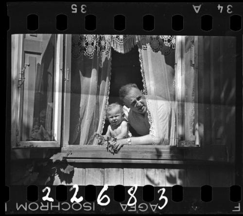 Man and a boy looking out the window