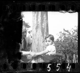 Man holding a boy by his hand