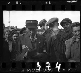 Jewish policeman surrounded by a group of residents