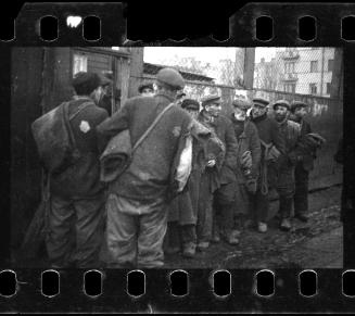 Line-up of men with bedrolls