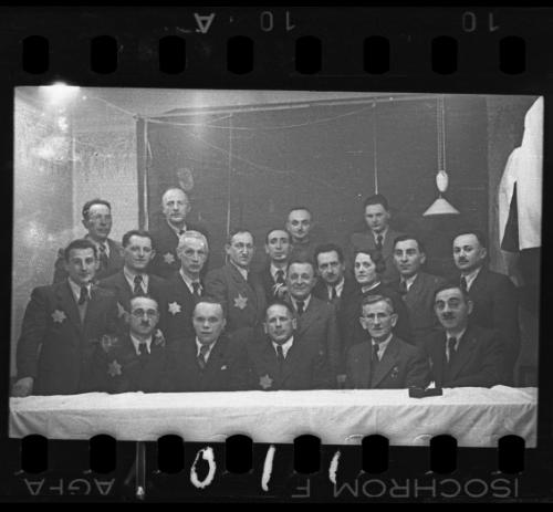 Group portrait of men and one woman [probably members of the Judenrat, the Jewish Council]