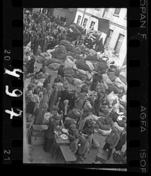 Residents sorting belongings left behind after deportation