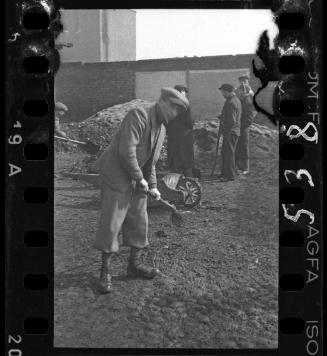 Men working outside in the ghetto