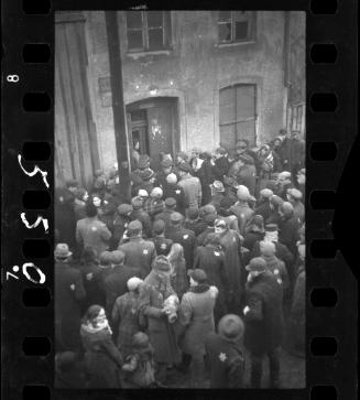 Residents gathered outside the doorway of building #44 in the ghetto
