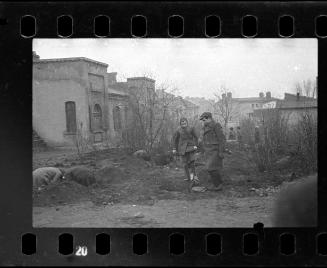 Children digging in the ground in search of provisons
