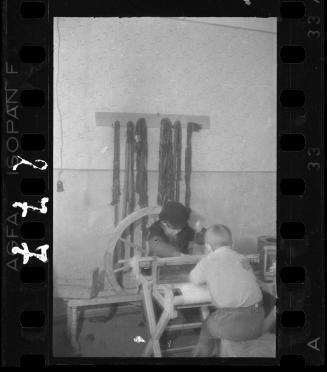 Two young boys weaving in a ghetto workshop