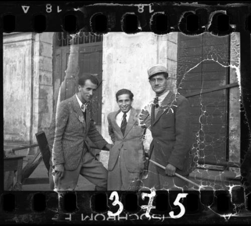 Three well dressed men [probably members of the Judenrat, the Jewish Council] standing outside a building