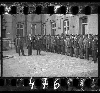 Jewish policemen standing in a line in a courtyard