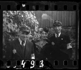 Two Jewish policemen and a woman smiling for the camera