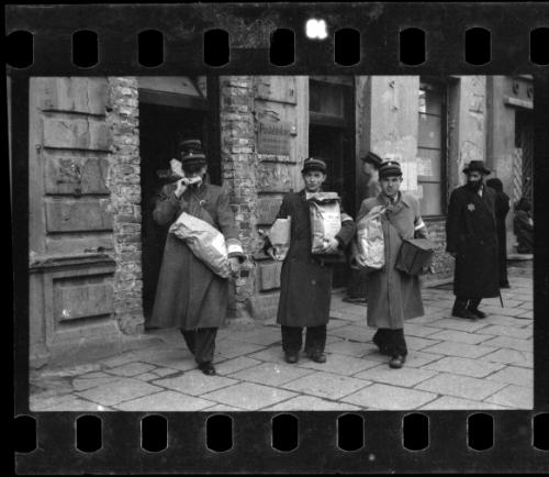 Jewish postmen with bags of bread and provisions