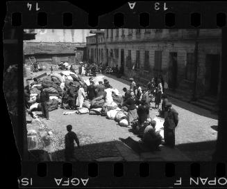Residents sorting belongings left behind after deportation