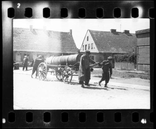 Fecal workers hauling a sewage collecting tank mounted on a wagon through the ghetto