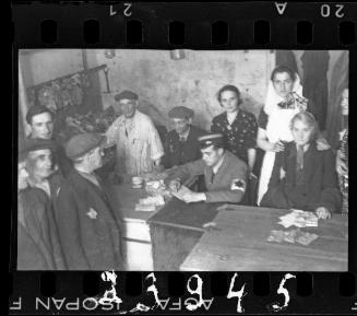 Jewish policeman making an exchange with residents