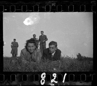 Couple posing on their elbows lying down