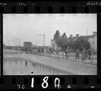 Massive deportation walking by water basin