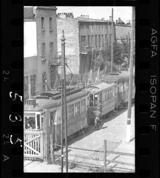 German official walking beside a streetcar outside the ghetto perimeter