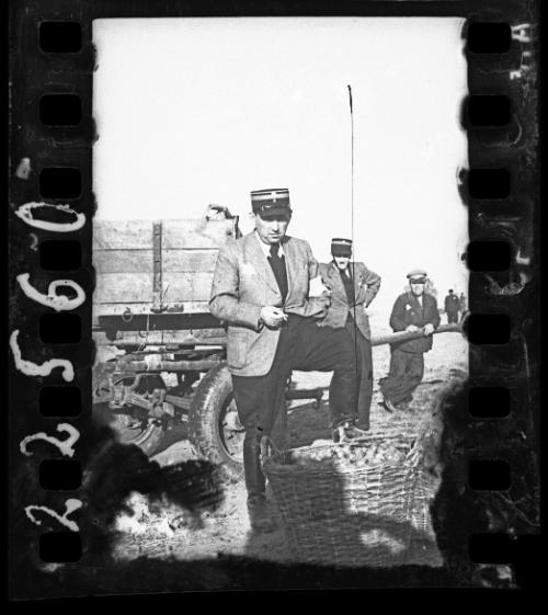 Jewish policeman standing over a basket of food