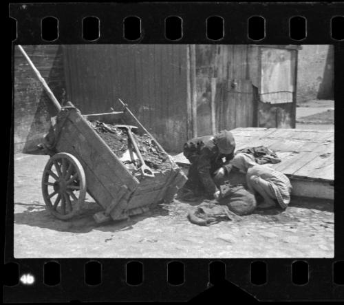 Children working on ghetto street with salvage cart