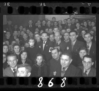 Large gathering of residents and Jewish police officers for a social occasion