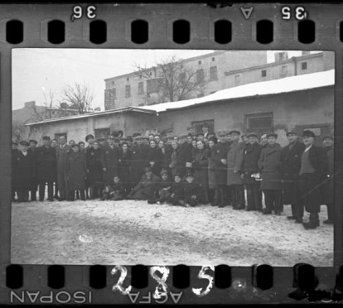 Large group of men and women workers and administrators of the Transport Department in the ghetto in winter