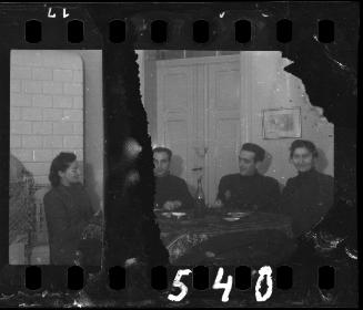 Four ghetto residents sitting around a table