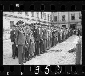 Jewish policemen standing in a line in a courtyard