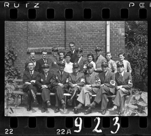 Group portrait of Jewish policemen and four unidentified women in the ghetto
