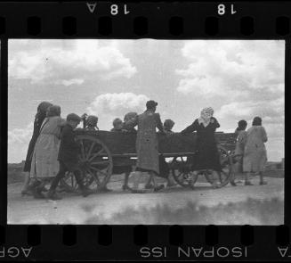 Residents pullinng a hearse through the ghetto